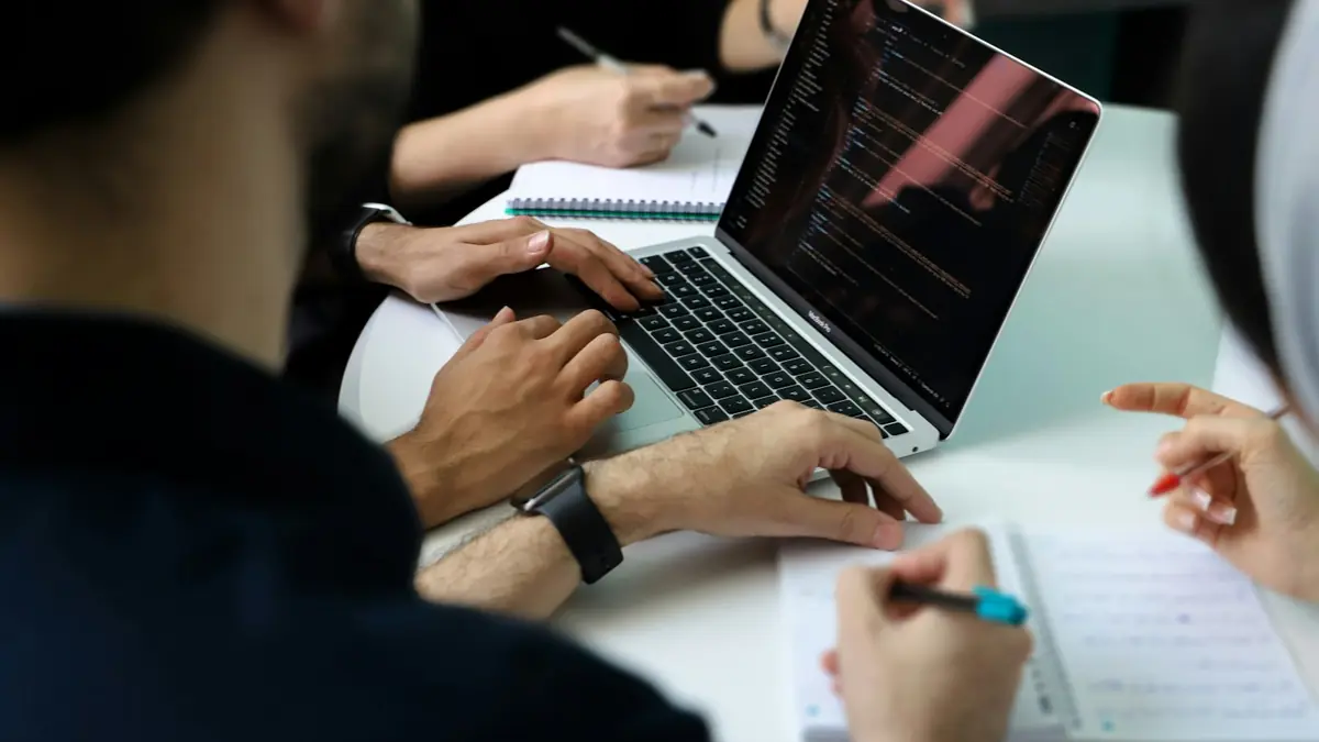 A team working around a laptop during planning