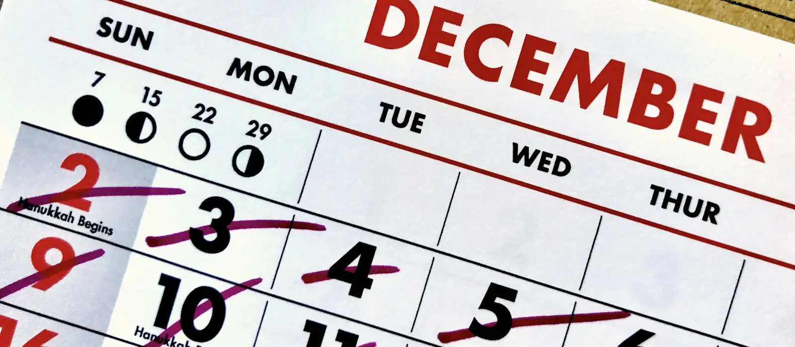 A December wall calendar with the days crossed off one by one
